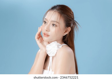 Young Asian beauty woman model long hair with natural makeup look on face and perfect clean skin on isolated blue background. Facial treatment, Cosmetology, Spa, Aesthetic, plastic surgery. Arkistovalokuva