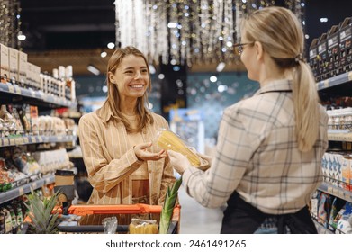 Стоковая фотография: Young customer woman wears casual clothes talk speak with seller shopping at supermaket store grocery shop buying with trolley cart choose products in hypermarket. Purchasing food gastronomy concept