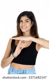 young smiling woman makes break stop and pause hand sign in sport on white background in body language concept Arkistovalokuva