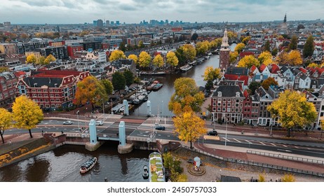 Aerial drone view Amsterdam autumn cityscape narrow old houses, canals, boats bird's eye view.  Arkistovalokuva