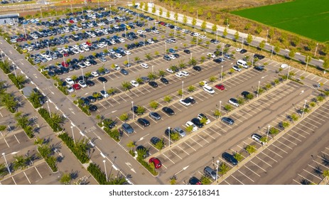 Aerial view of the Reggio Emilia AV Mediopadana station car park. There are many cars parked but also some empty spaces. – Ảnh có sẵn