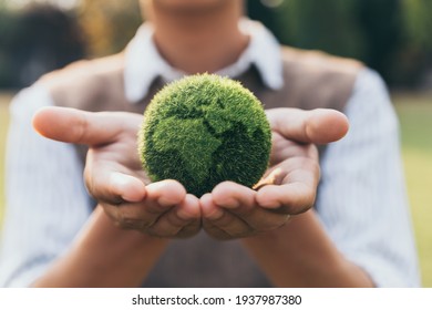 Asian teenager showing earth on hand, ecology and environment sustainable concept. Stock Photo