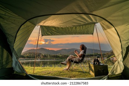 Asian woman travel and camping alone at natural park in Thailand. Recreation and journey outdoor activity lifestyle. Good morning and fresh start of the day. Stock Photo