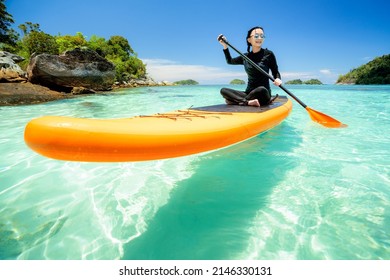 Asian woman relax on the beach with SUP BOARD at lipe island in summer season, Thailand Stock Photo
