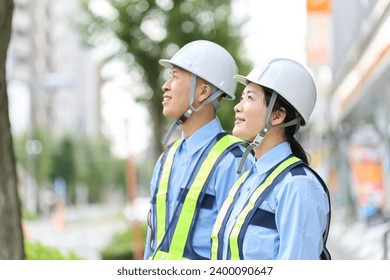 Asian men and women who work as security guards Stock Photo