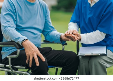 Asian people elderly man on wheelchair with caregiver nurse outdoor, , exemplifying the essence of holistic well-being and compassionate support. Nature Therapy Foto stock