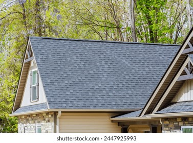 Asphalt shingles are used as roofing materials on roof of newly constructed house Foto stock