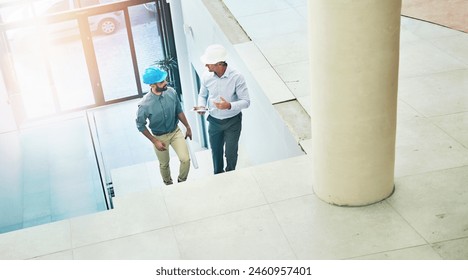 Architect, talking and businessman with hardhat in office, workplace and discussion for building design. Worker, planning and project with contractor, company and collaboration with developer Adlı Stok Fotoğraf