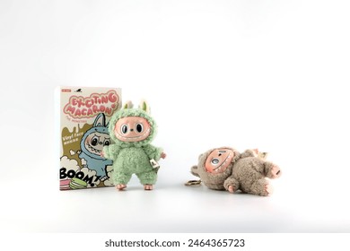 Редакционная стоковая фотография: art toys Labubu key chain collection from Pop Mart blind box collectable cute toys display on white shelf background at Pop mart flagship store during new release promotion event labubu macaron doll