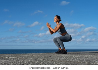 athletic brunette girl doing fitness doing exercises leading a h Arkistovalokuva
