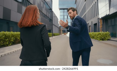 Back view worker two partners people business colleagues coworkers businessman businesswoman walk in city late man motivate woman hurry rush running to urgent meeting at office run together hurrying Foto stock