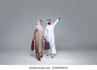 Beautiful arab middle-eastern happy couple of lovers wearing traditional abaya and kandora in studio - Arabic muslim adult people bonding and having fun in Dubai, United Arab Emirates Arkistovalokuva