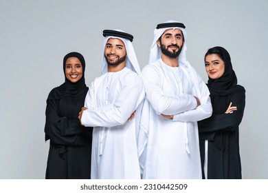 Beautiful arab middle-eastern women with traditional abaya dress and middle easter man wearing kandora in studio - Group of arabic muslim adults portrait in Dubai, United Arab Emirates Arkistovalokuva