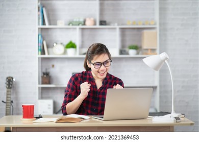 beautiful business asian young woman smile and working online with laptop and celebrating at home and work success cheerful and happiness, business concept.  Stockfoto