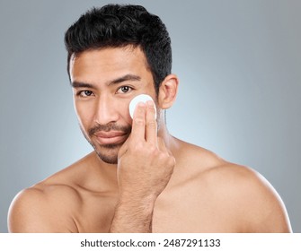 Beauty, cotton and portrait of masculine man in studio on gray background for cosmetic wellness. Dermatology, cleaning and skincare with face of confident person in bathroom for hydration or hygiene Adlı Stok Fotoğraf