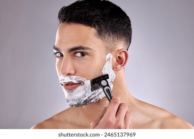 Beauty, portrait and shaving beard with man in studio on gray background for grooming or skincare. Aesthetic, hair removal and razor with confident model in bathroom for cosmetics or dermatology ภาพถ่ายสต็อก