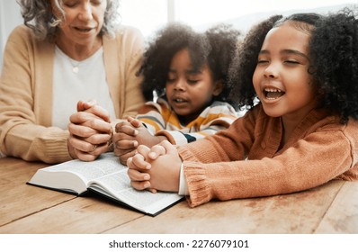 Bible, worship or grandmother praying with kids or siblings for prayer, support or hope in Christianity. Children education, family or old woman studying, reading book or learning God in religion Stock Photo