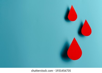 Blood drop symbol on blue background. Hemophilia day, blood donor day. Concept स्टॉक फ़ोटो