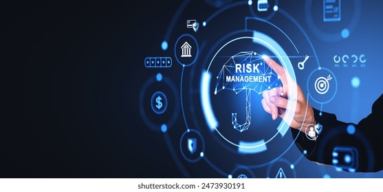 Businessman finger touch risk management umbrella hologram, diverse business safety icons on empty copy space background. Concept of money insurance and investment स्टॉक फोटो