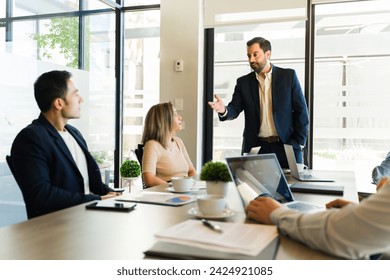 スーツを着た男性が会議室でビジネスの提案を共有するのを聞く実業家の写真素材