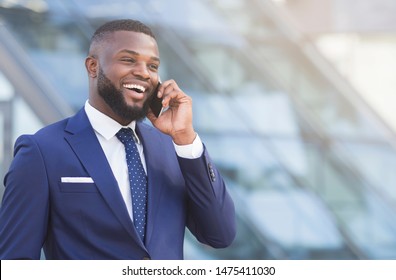 Business Communication. Cheerful Afro Businessman Having Phone Conversation In City Center. Copy Space: stockfoto