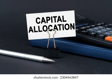 Business concept. On the table is a notebook, a calculator, a pen and a business card with the inscription - capital allocation Foto stock