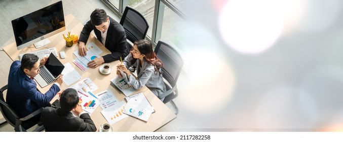 Business people group meeting shot from top widen view in office . Profession businesswomen, businessmen and office workers working in team conference with project planning document on meeting table . Stock-foto