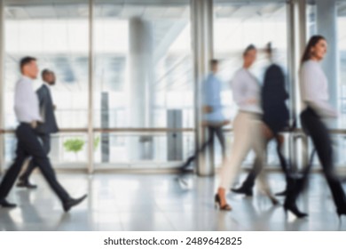 business people walking in the corridor of an business center, pronounced motion blur, crowded bright modern light office movement defocused. office background busy. talking and rushing in the lobby. Stockfoto