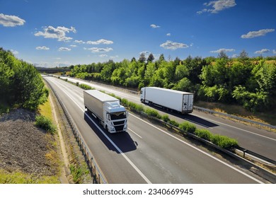 Cargo truck driving through landscape at sunset Stockfoto