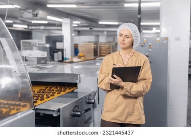 Chocolate factory woman worker inspecting production line conveyor with sweets candy. Concept control food industry. स्टॉक फ़ोटो
