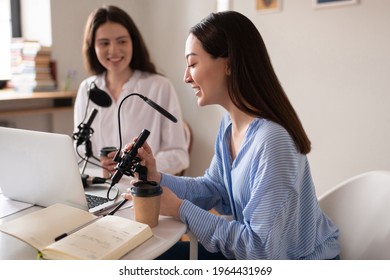 Cheerful Asian woman speaking during podcast with friend Adlı Stok Fotoğraf