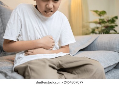 Child boy have flatulence,colic,indigestion,severe pain in abdomen caused by intestinal gas or obstruction in intestines,abdominal discomfort,Dyspepsia,difficulty in digesting food,digestive disorders Arkistovalokuva
