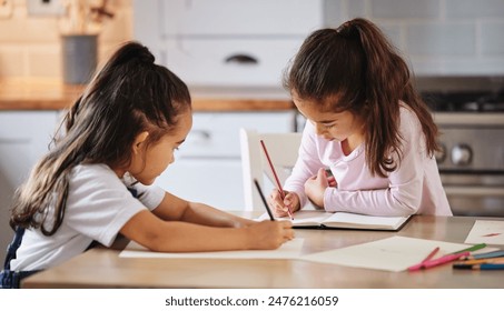 Children, notebook and learning in kitchen house with creative drawing, art and studying for education growth. Girls, artist and writing books, bonding and support for motor development at home Foto stock
