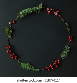 Christmas round frame made of natural winter things on dark blackboard. Flat lay. Christmas concept. Stock Photo
