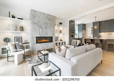 contemporary living room with open concept view through to dining room kitchen and a marble fireplace with gas fire Stock-foto