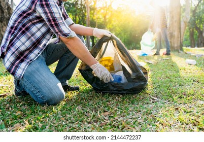 ゴミを集めて分別し、環境汚染や地球温暖化の問題、プラスチック廃棄物、自然の世話をさわやかにする。ごみ袋を運ぶ男性のボランティアコンセプトの写真素材