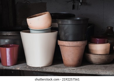 Colorful vases and containers Flowerpots and utensils in old basement Stock Photo