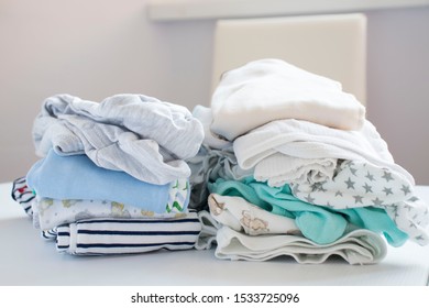 Colorful cotton folded clothes stack on white table empty space background,baby laundry.の写真素材