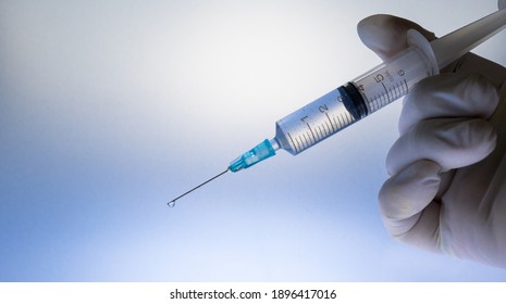 Coronavirus (COVID 19) Vaccine and syringe injection.
Close up vaccination vial dose flu shot drug needle syringe.  Arkistovalokuva