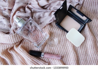 Cosmetic on pink background. Perfume bottle, lipstick, powder, mirrorのエディトリアル写真素材