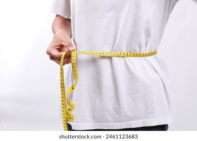 노란색 줄자 테이프로 허리를 측정 하는 파란색 셔츠에 여자를 닫습니다. 체중 감소, 날씬한 몸매, 건강한 라이프 스타일 개념. 수치를 조절하고 칼로리를 세어 보세요. 성공적인 다이어트 계획. 스톡 사진