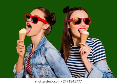 Close up face portrait of two brunette hair dreamy charming lovely cute gorgeous lady in glasses spectacles isolated on yellow vivid background eating sugar tasty yummy appetiser snack Stock-foto