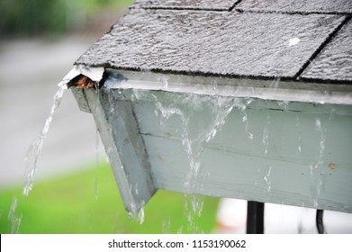 close up on rain flowing down the roofの写真素材