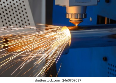 Close up scene the fiber laser cutting machine cut the stainless steel tube and sparkling light. The hi-technology sheet metal manufacturing process by laser cutting machine.  Arkistovalokuva