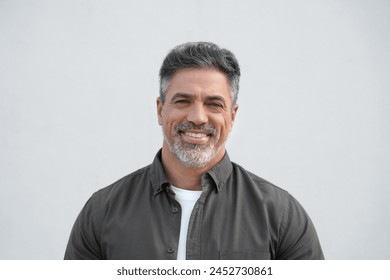 Closeup face headshot portrait of middle age mature adult man. Freelancer entrepreneur isolated on white background. Happy smiling handsome 40 years old latin hispanic businessman looking at camera Foto stock