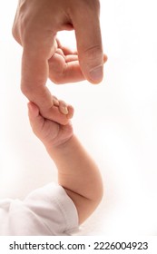 Close-up little hand of child and palm of mother and father. The newborn baby has a firm grip on the parent's finger after birth. A newborn holds on to mom's, dad's finger.  ภาพถ่ายสต็อก