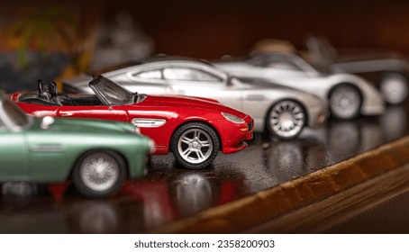 Classic model vehicles or toy vehicles. Miniature collection of automobiles. Retro car models on shelf. Retro style cars. Toy cars with retro design. Stock Photo