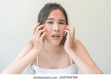Dermatology, scratch asian young woman, girl expression face worry, hand itch, itchy allergy or allergic sensitive reaction, red spot or rash on her facial. Beauty care from skin problem treatment. Stockfotó