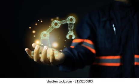 A design or maintenance engineer holds a robotic arm in his hand after a successful design. The manufacturing technology of the future, artificial intelligence or AI in the modern industrial sector.: stockfoto