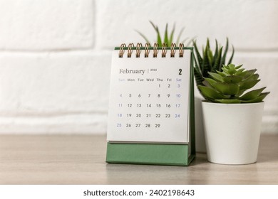 Desk calendar for February 2024 and on the table with copy space Stockfoto